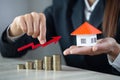 Businessman Holding  Graph Over The Increasing House Miniature, Real estate investment,investment mortgage finance and home loan Royalty Free Stock Photo