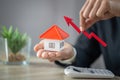 Businessman Holding  Graph Over The Increasing House Miniature, Real estate investment,investment mortgage finance and home loan Royalty Free Stock Photo