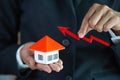 Businessman Holding  Graph Over The Increasing House Miniature, Real estate investment,investment mortgage finance and home loan Royalty Free Stock Photo