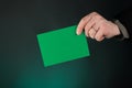 Businessman Holding a Green Card, Empty, Copy Space, Gradient Green. Royalty Free Stock Photo