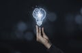 Businessman holding half of virtual lightbulb and brain on blue bokeh background , Smart thinking idea and inspiration innovation Royalty Free Stock Photo