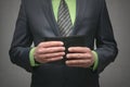 Businessman holding in hands a black leather wallet, close up photo. Royalty Free Stock Photo