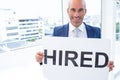 businessman holding a hired sign