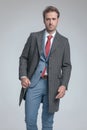 Businessman holding his coat while posing with attitude Royalty Free Stock Photo