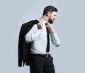 Businessman holding his jacket over his shoulder and straightens his tie Royalty Free Stock Photo