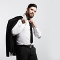 Businessman holding his jacket over his shoulder and straightens his tie Royalty Free Stock Photo