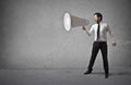 Businessman holding a huge megaphone