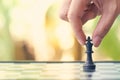 Businessman holding a King Chess is placed on a chessboard.using as background business concept and Strategy concept with copy spa