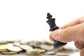 Businessman holding a King Chess is placed on a pile of coins. using as background business concept and Strategy concept Royalty Free Stock Photo