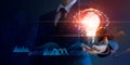 Businessman holding light bulb and brain network with icon business