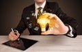 Businessman holding a light bulb, social media concept Royalty Free Stock Photo