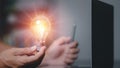 Businessman holding a light bulb showing ideas to brainstorm, imagine, inspire, innovative technology concepts through thinking,