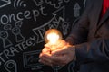 Businessman holding lightbulb in hand Royalty Free Stock Photo