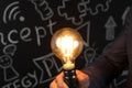 Businessman holding lightbulb in hand Royalty Free Stock Photo