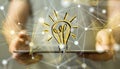 Businessman holding a lightbulb icon on a tablet- idea and innovation concept Royalty Free Stock Photo