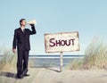 Businessman Holding loudspeaker with Signboard on Beach