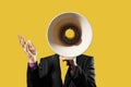 Businessman Holding Megaphone against yellow background Royalty Free Stock Photo