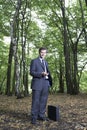 Businessman Holding Mobile Phone In Forest Royalty Free Stock Photo