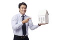 Businessman holding model house