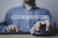 Businessman holding mouse and computer keyboard with search engine bar website on the table for searching information from Royalty Free Stock Photo