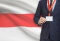 Businessman holding name card badge on a lanyard with a national flag on background - Belarus