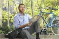 Businessman Holding Newspaper By Bicycle Royalty Free Stock Photo