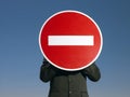 Businessman Holding 'No Entry' Sign In Front Of Face