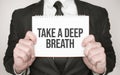 Businessman holding a notepad with text Take a deep breath Royalty Free Stock Photo