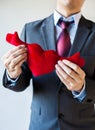 Businessman holding open armed heart with hands - warm welcome a Royalty Free Stock Photo
