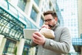 Businessman holding paper bag over mouth as if having a panic attack Royalty Free Stock Photo