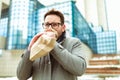 Businessman holding paper bag over mouth as if having a panic attack Royalty Free Stock Photo