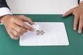 Businessman holding part of Jigsaw puzzle on the table,Business Royalty Free Stock Photo