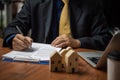 businessman holding a pen looking at documents Selling real estate, insurance, buying a house and paying land taxes. Making Royalty Free Stock Photo