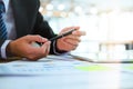 Businessman holding pen and planing analyse the business strategy. Royalty Free Stock Photo