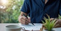 Businessman holding pen and pointing paper chart summary analyzing annual business report with using laptop at room office desk Royalty Free Stock Photo