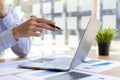 Businessman holding a pen pointing to a laptop screen to check financial information from files sent by the finance department via Royalty Free Stock Photo