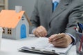 businessman holding a pen signing a house purchase contract. Real estate business concept land and rental, insurance and bank loan Royalty Free Stock Photo