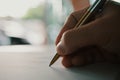 Businessman holding pen writing on paper for new appointments information in organizer concept Royalty Free Stock Photo