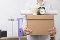 Businessman holding personal items box ready moving leaving