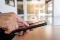 Businessman holding a phone with a low battery charge screen While working on table, I need to find a quick charger Royalty Free Stock Photo