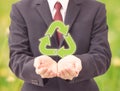 Businessman holding recycle icons