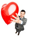 Businessman holding red heart balloon