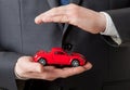 Businessman holding a red toy car Royalty Free Stock Photo