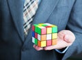 Businessman holding rubik cube in his hands Royalty Free Stock Photo