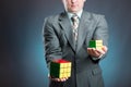Businessman holding rubik cube in his hands
