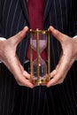 Businessman holding a sand timer