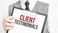 Businessman holding sheet of paper with a message Client Testimonials Royalty Free Stock Photo