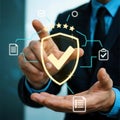 Businessman holding a shield with a checkmark, representing security and quality Royalty Free Stock Photo