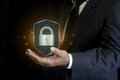 Businessman holding shield with keyhole inside closed padlock cyber security concept. Data password protection internet network Royalty Free Stock Photo