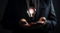 A businessman is holding a shining lightbulb. Generative ai